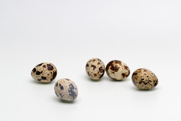 Spotted quail eggs on a white background