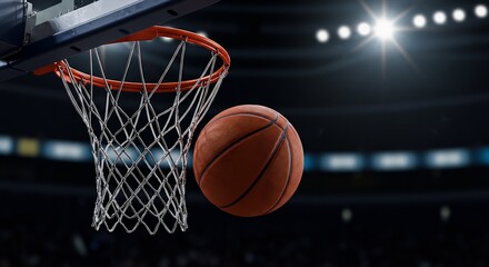 Fototapeta premium Dramatic Close-Up of a Basketball Swishing Through the Net in a Professional Stadium Arena