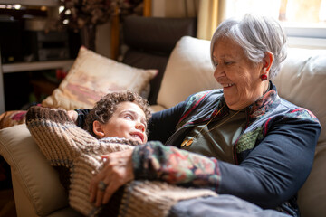 Grandmother and grandchild sharing a loving moment on the sofa
