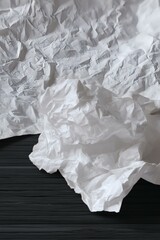 Obraz premium Wrinkled White Paper Texture on Dark Wooden Background