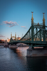 The bridge over the Danube River in Budapest, Hungary. The sunset sunlight falls on the city and its beautiful architecture.