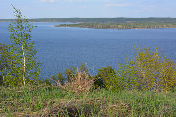 Scenic view of a lake with trees and blue sky
