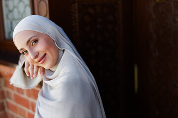 beautiful young face of caucasian muslim woman in hijab	
