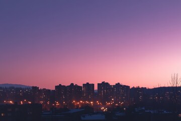 Twilight cityscape, buildings glowing faintly against a vibrant purple and pink sky