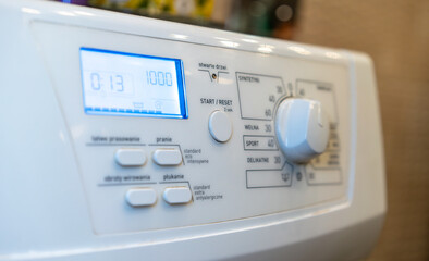 washing machine smart digital control panel close-up with knob and buttons labels in polish