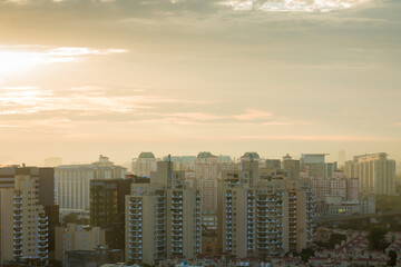 Obraz premium Aerial view of Gurgaon,Haryana,India city skyline at sunset during monsoon.Gurugram cityscape with modern architecture,urban,commercial ,luxury residential apartment buildings.Delhi NCR business hub.