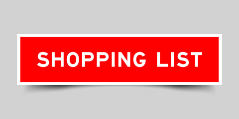 Red color square shape sticker label with word shopping list on gray background