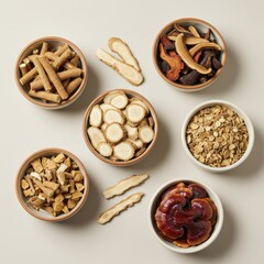 Assortment of Chinese herbal medicine ingredients in bowls on beige background