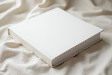 Fototapeta premium Blank-white-book-on-linen-fabric-wedding-album-photography-props-mockup-isolated