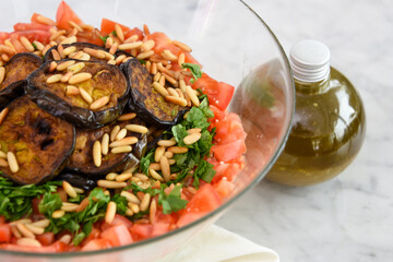 Mediterranean Couscous Salad with Grilled Eggplant on napkin featuring fluffy couscous, tomatoes,...