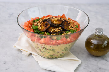 Fresh Mediterranean Couscous Salad with Grilled Eggplant featuring couscous, tomatoes, parsley,...