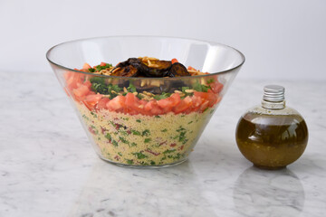 Mediterranean Couscous Salad with Grilled Eggplant featuring fluffy couscous, tomatoes, parsley,...