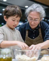 Fototapeta premium Elderly asian female and young asian boy baking together in kitchen