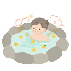 柚子風呂の温泉に入ってのんびりする中年女性