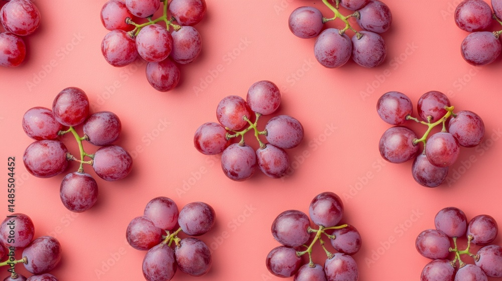 Poster a bunch of grapes are arranged in a pattern on a pink background