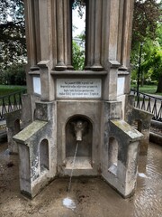 Old stone fountain in park garden
