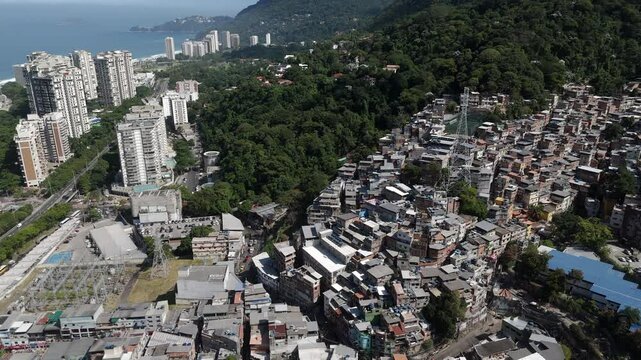 Aerial view of Rio de Janeiro, Brazil, tilt down shot flying over Rocinha, the largest favela in Brazil, on a sunny day.