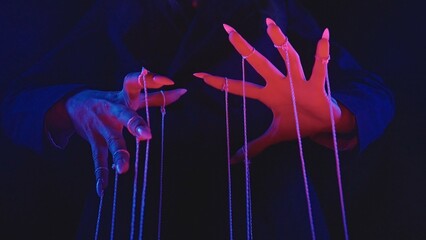 Mysterious Hands Manipulating Strings in Dramatic Light