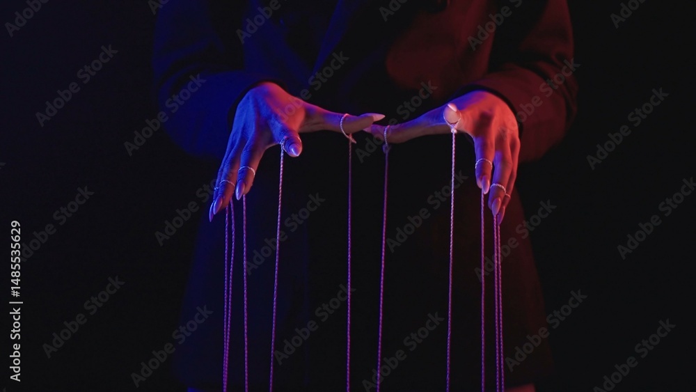 Poster mysterious figure controlling strings in dark shadows