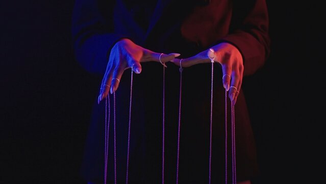Fototapeta Mysterious Figure Controlling Strings in Dark Shadows