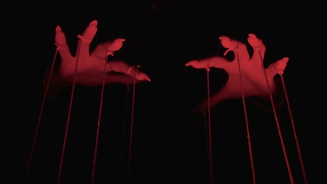Fototapeta Dark Manipulation: Hands Controlling Red-String Puppets