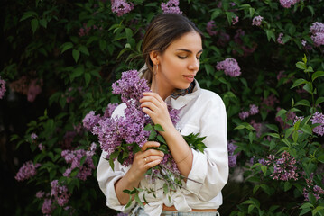 Woman Embraces Fragrant Lilac Blooms In Spring