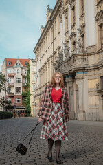 young beautiful woman in vintage suit in european city