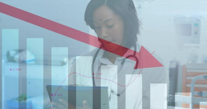 Female medical professional reviewing clipboard in hospital area, showing bar charts and red arrow