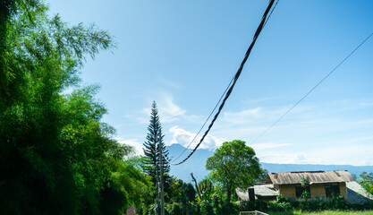 Scenic Rural Landscape with Electric Pole and Mountain View


