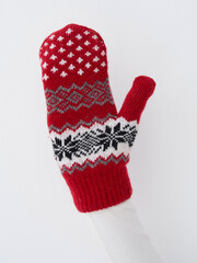 Warm red knitted mittens with patterns perfect for chilly winter days