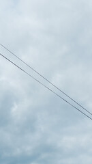 Electric Cable with Cloudy Sky Background

