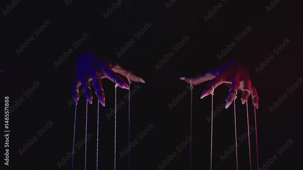 Poster mysterious hands and strings in dramatic low light