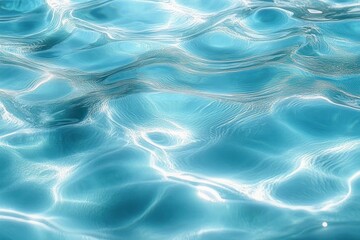 Close-up view of clear blue water surface with light reflections creating gentle ripples and waves