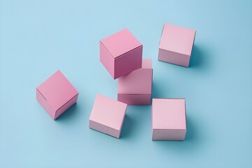 Pink Cardboard Boxes Arranged on a Soft Blue Background with Elegant Contrast