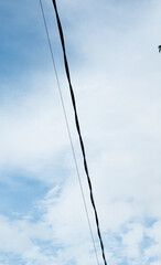 Electric Wire Crossing Over Soft Blue Sky

