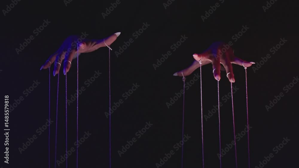 Poster mysterious hands controlling puppet strings in dark atmosphere