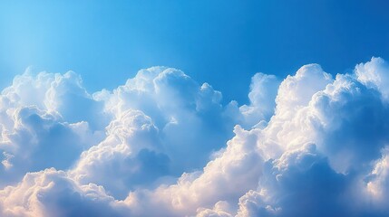 Fluffy white cumulus clouds illuminated by soft sunlight against a clear blue sky evoking calm and serenity