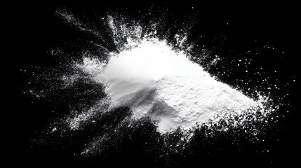 A dynamic explosion of white powder against a black background, creating a striking visual contrast.