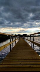 Obraz premium wooden bridge over the sea at the sunset