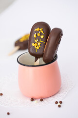chocolate ice cream on a stick isolated on a white background. Chocolate Popsicles with Gold Sprinkles