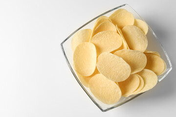 Tasty potato chips on white background, top view. Space for text