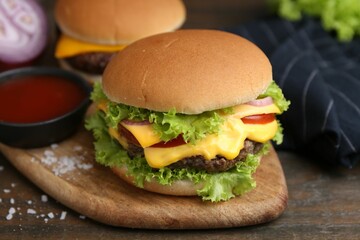 Tasty cheeseburgers served on wooden table, closeup
