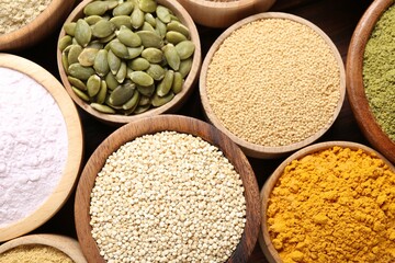 Different superfoods in bowls on table, flat lay