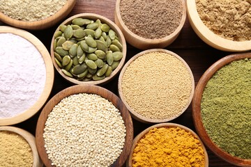 Different superfoods in bowls on table, flat lay