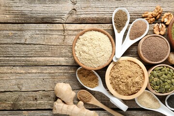 Different superfood products on wooden table, flat lay. Space for text