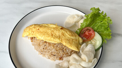 Homemade Chinese fried rice with egg and vegetables chicken and fried eggs served on a plate