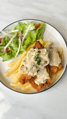classic traditional italian chicken parmigiana with cheese, tomato sauce meal and french fries