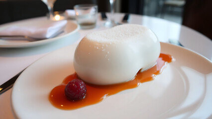 Michelin Style Coconut Bavarois Served on Elegant Plate in Sophisticated Restaurant Setting
