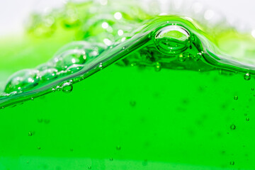 Water wave, close up of vibrant green liquid with bubbles, capturing dynamic movement and...