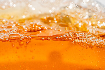 Close up bright orange Oil or beer splash texture and nature waves, Beautiful waves curve and little bubbles smooth for graphic design and background, Oil Bubbles, Soft beer bubbles, Selective focus